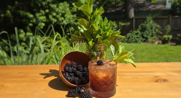 We Demand a Shrubbery craft cocktail with blackberries and mint in a rocks glass