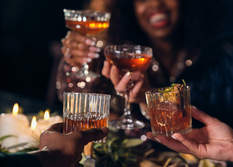 group of people, dinner party, holiday, raising glasses, cocktails, old fashioned cocktails